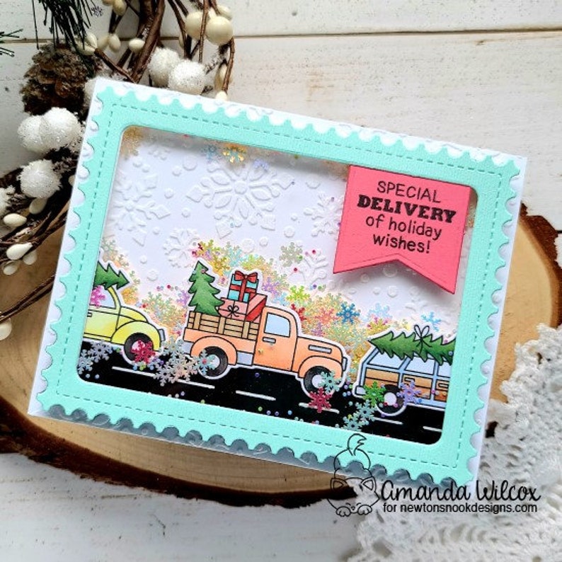 May include: A handmade holiday card featuring three colorful trucks carrying gifts and Christmas trees. The card has a light blue frame with a snowflake background and the text "SPECIAL DELIVERY of holiday wishes!"