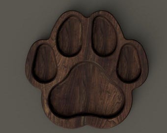 May include: A dark brown wooden serving tray shaped like a paw print with four smaller indentations around a larger central indentation.