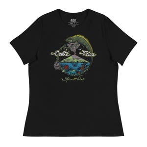 May include: Black t-shirt featuring a graphic design of a volcano, a green iguana, and the text "Costa Rica Pura Vida".