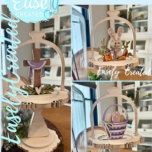 May include: A digital cut file featuring Easter-themed wooden decorations. The designs include a cross with a purple drape, a bunny with carrots, and a basket of eggs. The text "Easely Created" is visible.