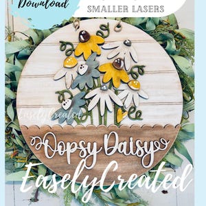 May include: A wooden door hanger featuring a daisy design with yellow, white, and blue flowers. The text "Dopsy Daisys" and "Easely Created" are displayed on the bottom. The words "Instant Digital Download" are also visible.