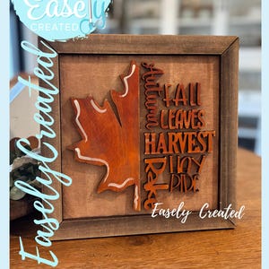 Peut inclure: Panneau en bois encadré sur le thème de l'automne, avec une feuille et les mots "Fall Leaves Harvest Joy Ride". Le panneau comprend également le texte "Easely Created" et "Digital Cut File."
