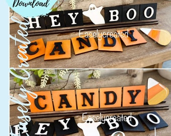 Könnte beinhalten: Ein Halloween-Holzschild mit den Worten "Hey Boo Candy" in schwarzen und orangefarbenen Buchstaben. Das Schild ist mit einem Geist und einem Zuckermais verziert.
