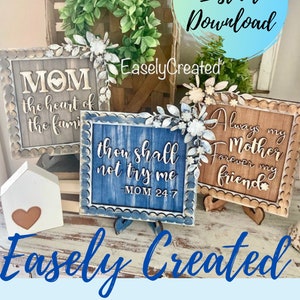Puede incluir: Tres letreros de madera con acentos florales decorativos y bordes festoneados. Los letreros presentan el texto "MOM the heart of the family", "thou shall not try me -MOM 24:7", y "Always my Mother Forever my friend".