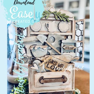 May include: A distressed white and gray miniature kitchen cabinet with open doors, filled with wooden baking-themed decorations. Includes a rolling pin, flour container, and a tag that says "Baked with Love". The text "Instant Digital Download Easely Created" is also visible.