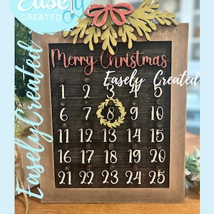 May include: Wooden Christmas advent calendar with a dark wood background and a light wood frame. The calendar features the text "Merry Christmas" and numbers 1-25. The top has a red bow and green leaves. The text "Easely Created" is also visible.