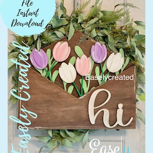 May include: A wooden envelope with a "hi" sign and a bouquet of pink, purple, and white tulips. The envelope is surrounded by green leaves. The text "Easlycreated" is visible on the envelope.