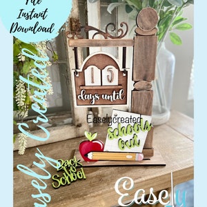 May include: A wooden sign with a countdown to the start of school. The sign says "15 days until school's out". There is a red apple and a yellow pencil next to the sign. The sign is on a wooden surface.