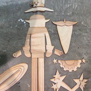May include: A wooden craft kit to assemble a Uncle Sam figure. The kit includes pieces for the body, hat, beard, stars, and a banner.
