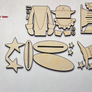 May include: Wooden craft kit to assemble a Uncle Sam figure. The kit includes pieces for the hat, body, stars, and a base. The text "use for larger laser (avoid backdraft)" is included on the image.