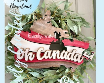 Puede incluir: Un recorte de madera de Canadá con un diseño de rayas rojas, blancas y rojas y las palabras "Oh Canada" en fuente blanca. El recorte está rodeado de una corona verde.