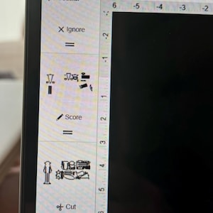 May include: A computer screen displaying a design program with a zoom level of 67%. The program has a menu on the left side with options to ignore, score, and cut. The design area is black and empty.