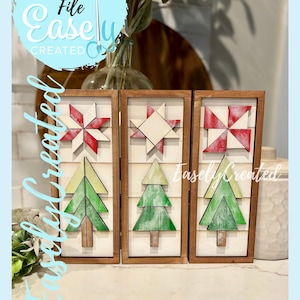 May include: Three wooden framed wall art pieces with a Christmas theme. Each piece features a star or pinwheel design in red and white, and a green Christmas tree. The text "Digital Cut File Easely Created" is visible.