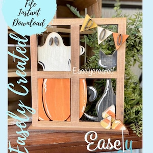 May include: A wooden window frame with a ghost, pumpkin, black cat, and candy corn decorations. The window frame is painted brown and the decorations are painted in various colors. The text "BOO" is displayed on a banner above the window.