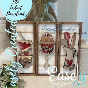 May include: Three wooden signs with a farmhouse theme. The signs feature a red and brown mixing bowl, a brown cake, and a brown pitcher with a red heart. The signs are framed in brown wood and have a white background with a wood grain texture. The signs are labeled "Easley Created".