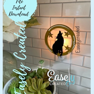 May include: A wooden nightlight featuring a silhouette of a wolf howling at the moon with stars. The nightlight is lit and plugged into an outlet. The text "Easily Created" is visible in the image.