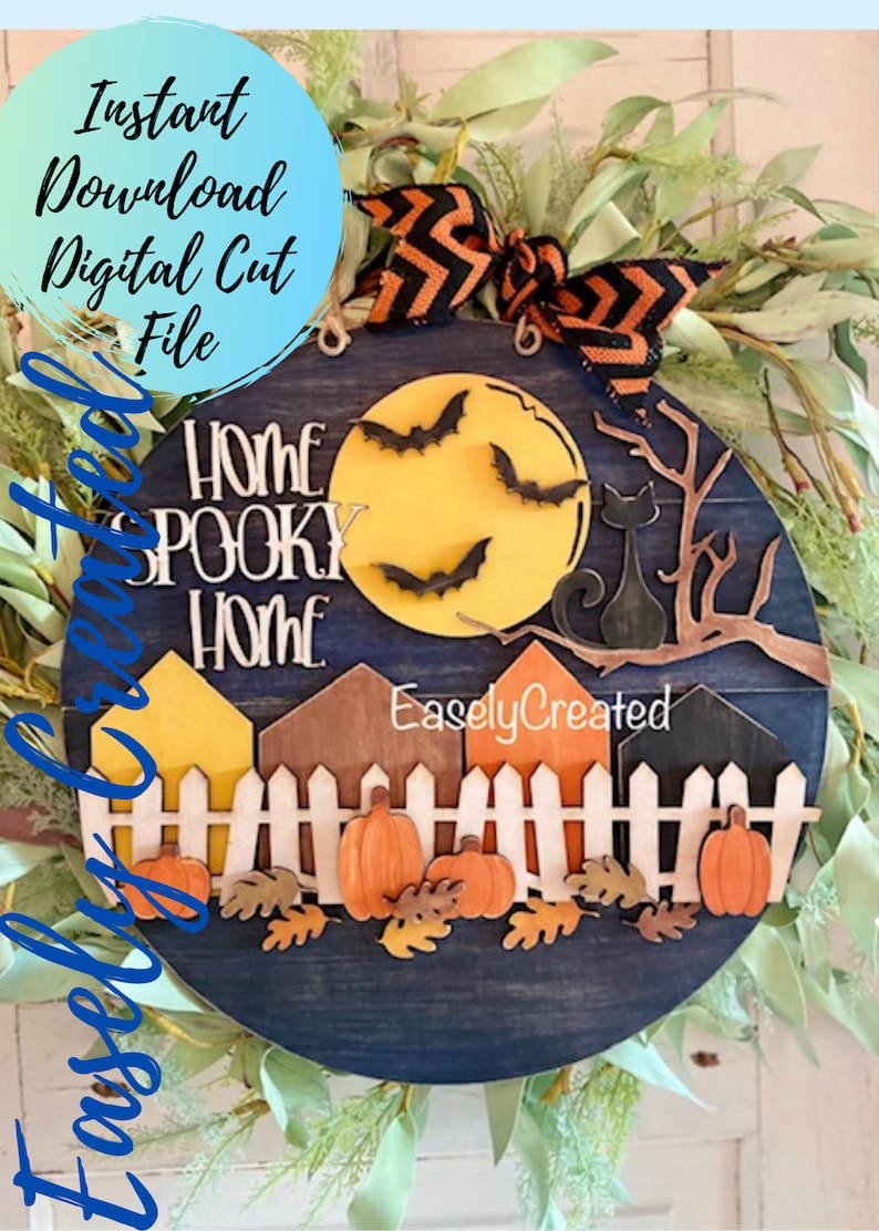 May include: A round wooden sign with a blue background and a yellow moon with bats flying around it. The sign says "Home Spooky Home" and has a black cat sitting on a branch. There are also houses, a fence, pumpkins, and leaves on the sign. The sign is decorated with a black and orange ribbon.