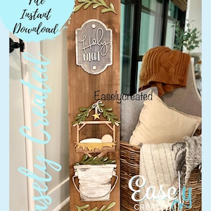 May include: A wooden sign with a Christmas nativity scene, a bucket, and a sign that says "Holy Night". The sign is decorated with green leaves and a star.