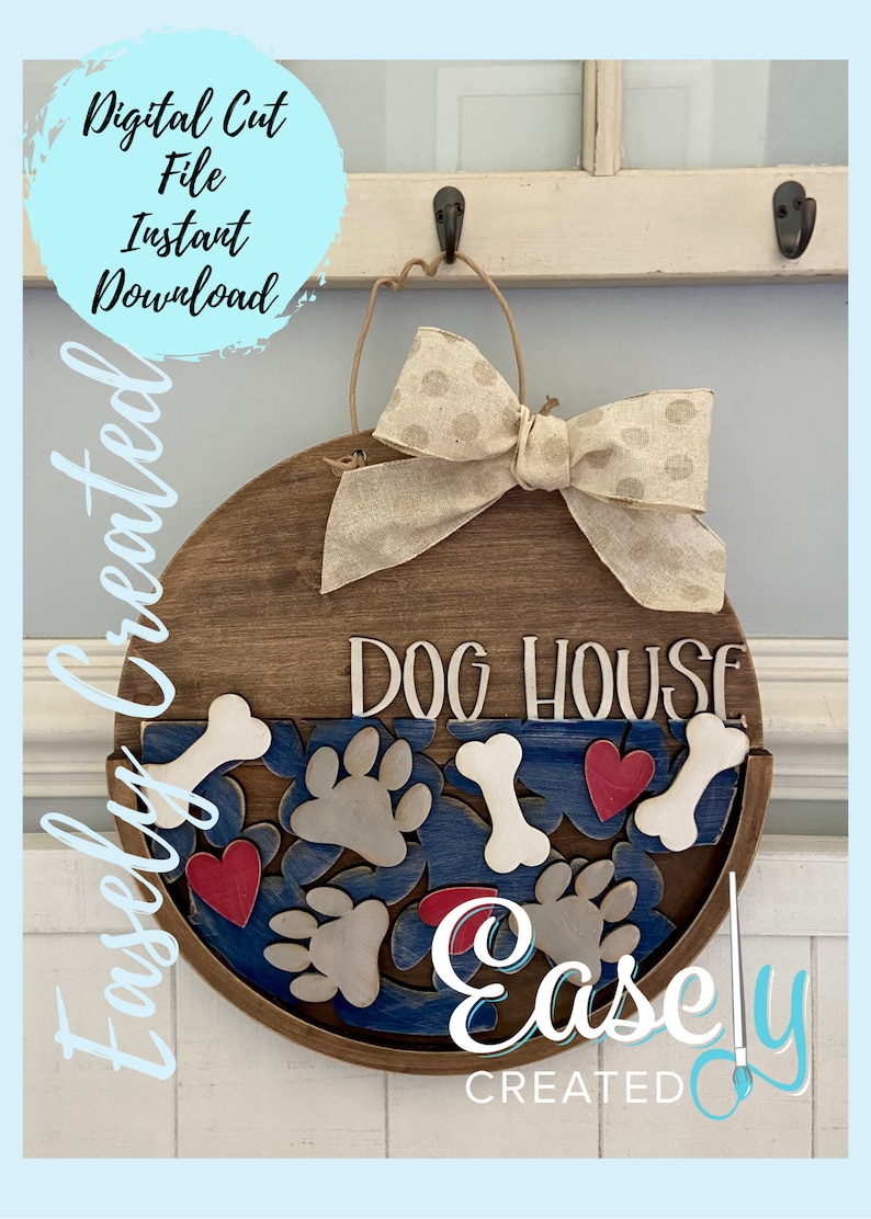 May include: A round wooden sign with the text "Dog House" in white lettering. The sign is decorated with a beige bow, paw prints, bones, and red hearts. The sign is hanging on a white hook.