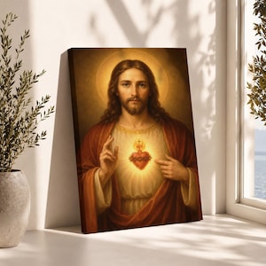 May include: A rectangular canvas print featuring a portrait of Jesus Christ with long brown hair and a beard. He wears a red robe over a white tunic, gesturing toward a glowing, radiant Sacred Heart adorned with a crown of thorns and a cross.
