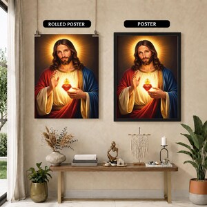 May include: Two wall art displays featuring the Sacred Heart of Jesus. The left image is labeled ROLLED POSTER and the right image is labeled POSTER. Both show a portrait of Jesus with a glowing heart, wearing red and blue robes, with a golden halo.