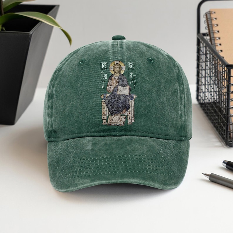 Classic washed green cap featuring an intricate embroidery design of Christ sitting on a throne, symbolizing faith and spirituality. This unisex hat provides a comfortable fit with its adjustable strap and timeless design, making it a perfect gift for Christians or anyone looking to express their beliefs. Ideal for casual outings, church events, or as a meaningful accessory. Available in various sizes for a customized fit.