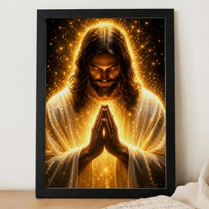 May include: A framed wall art print depicting a figure with long hair and a beard, hands pressed together in a prayer position. The figure is wearing a white robe, surrounded by a radiant golden glow and shimmering particles against a dark background.