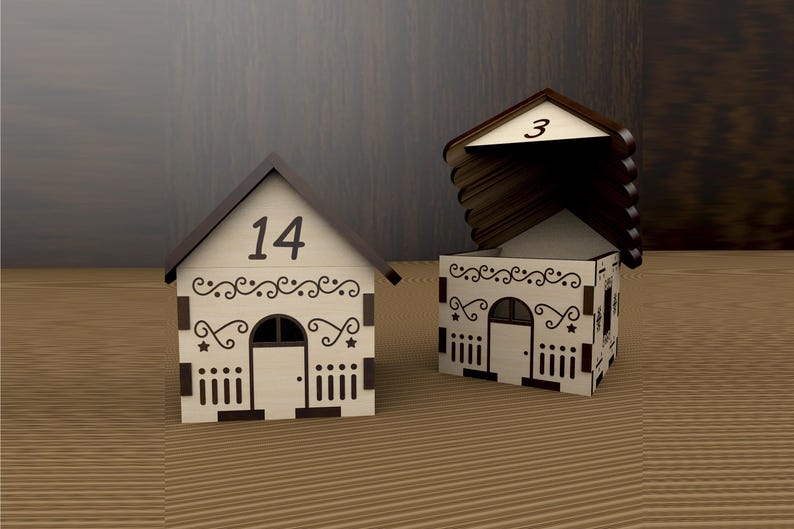 May include: Two decorative wooden house-shaped boxes. One has the number 14 on the roof, the other has the number 3. Both have decorative cut-out designs, including a door, windows, and star accents. The houses are on a wooden surface.