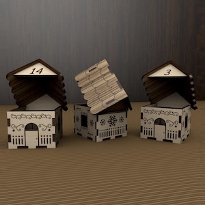 May include: Three decorative wooden houses with brown roofs and white walls. The houses have intricate cut-out designs, including doors, windows, and decorative patterns. Two houses have the numbers 14 and 3 on their roofs. One house has a snowflake design.