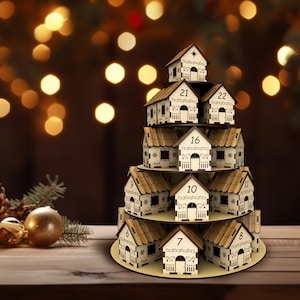May include: A wooden Christmas advent calendar shaped like a tiered stack of houses. Each house has a number from 7 to 22. The houses are beige with brown roofs and white trim. A candle and ornaments are in the foreground.