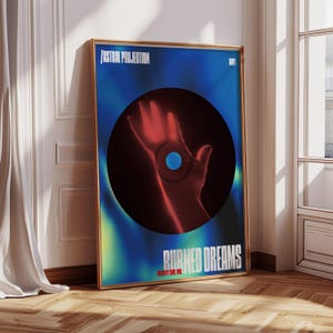 May include: A framed art print with a gold border. The artwork features a hand in red tones emerging from a black circle against a blue and green gradient background. Text at the top reads "/ ASTRAL PROJECTION" and at the bottom "BURNED DREAMS".