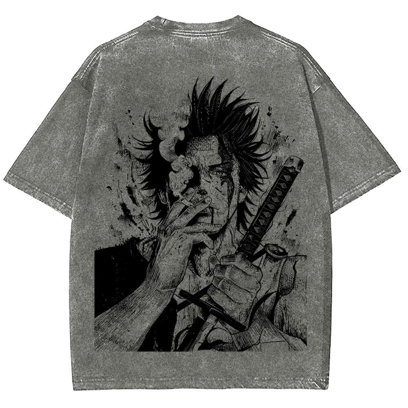 May include: Gray acid wash t-shirt featuring a black graphic of a person smoking a cigarette and holding a sword. The graphic is a detailed illustration with a manga or anime style.
