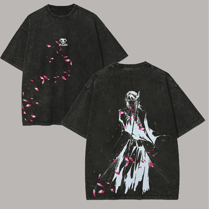 May include: Dark gray t-shirt with a graphic design. The front features a small skull logo with the word "BNEAH" and pink flower petals. The back displays a white and blue illustration of a character with pink petals.