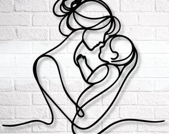 Puede incluir: Arte de pared de metal negro que representa a una madre y un niño en un diseño de línea continua. La madre sostiene al bebé cerca, con sus rostros tocándose. La obra de arte está montada en una pared de ladrillos blancos.