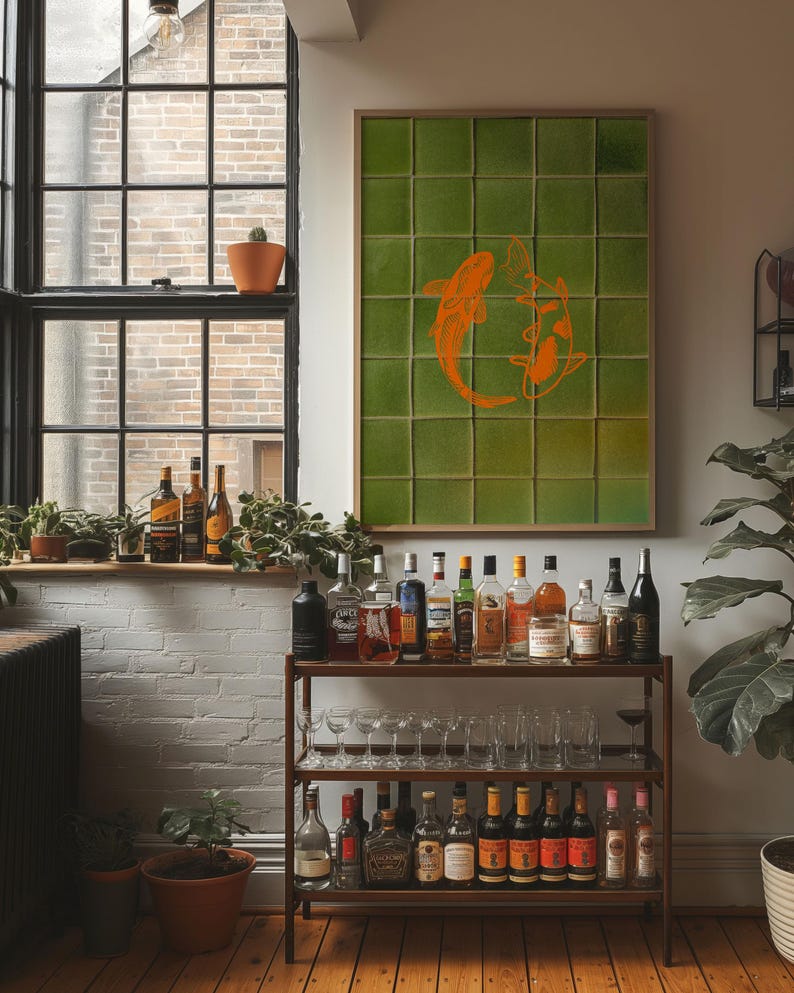 May include: A home bar setup featuring a wooden bar cart with various liquor bottles and glassware. A framed green artwork with orange koi fish hangs on the wall. A window with plants and bottles is in the background.