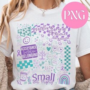 Op de afbeelding: Wit t-shirt met een kleurrijk grafisch ontwerp. Het ontwerp bevat de tekst "Cornelia de Lange Syndrome Awareness", "Acceptance Inclusion Belonging" en "Small But Mighty", samen met verschillende krabbels in teal en paars.