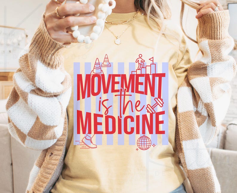 May include: A light yellow t-shirt with the text "MOVEMENT is the MEDICINE" in red. The shirt features graphics of a dumbbell, a running shoe, a disco ball, and other fitness-related icons. The shirt is part of a fitness or wellness collection.