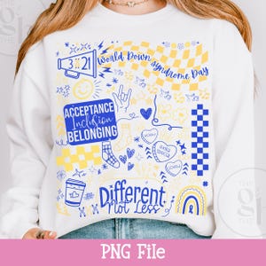 May include: White sweatshirt with a blue and yellow graphic design. The design includes the text "World Down Syndrome Day", "Acceptance Inclusion Belonging", and "Different Not Less". The graphic also features hearts, socks, and a rainbow.