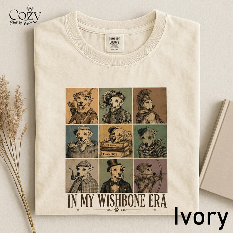 A white t-shirt with a collage of nine illustrations of dogs in various poses and outfits, along with the text "IN MY WISHBONE ERA" printed on it.