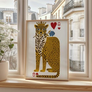 May include: Framed art print featuring a stylized leopard wearing a crown and holding a blue rose. The leopard has a yellow and brown spotted coat. Playing card symbols, including a heart and a queen, are also present in the design.