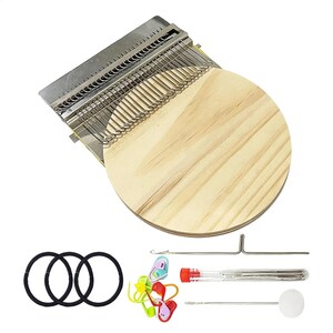 May include: A darning loom tool featuring a circular wooden base and a metal hook plate with multiple wire hooks. The set includes three black elastic bands, a collection of colorful plastic stitch markers, a metal needle, and a clear tube of needles.