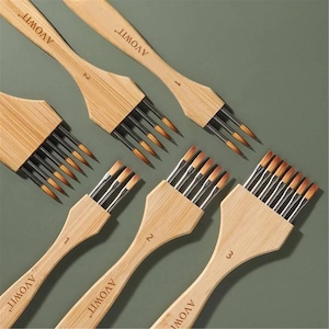 May include: A collection of six multi-tip paint brushes with light wood handles, each featuring the brand name AVOWIT and a numerical size indicator. The brushes have silver metal ferrules holding multiple fine-tipped synthetic bristles.