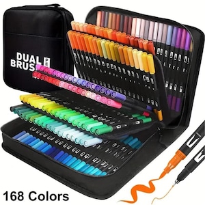 May include: A set of 168 dual brush pens in a black zippered carrying case. The pens are organized in tiered slots, displaying a wide spectrum of colors including reds, oranges, yellows, greens, blues, and purples. The case features the text DUAL BRUSH PEN.