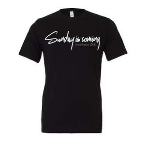 May include: Black t-shirt with white text that reads "Sunday is coming Matthew 28:6".