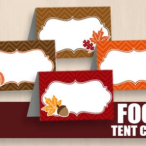May include: Four printable food tent cards with fall-themed designs. The cards feature a pumpkin, a turkey, and autumn leaves. Each card has a blank space for writing the name of the food.