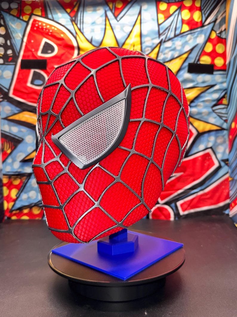 May include: A white ceramic mug with a black handle and the text "But First, Coffee" in a bold, black font. The mug is set against a blurred background, highlighting its simple design.