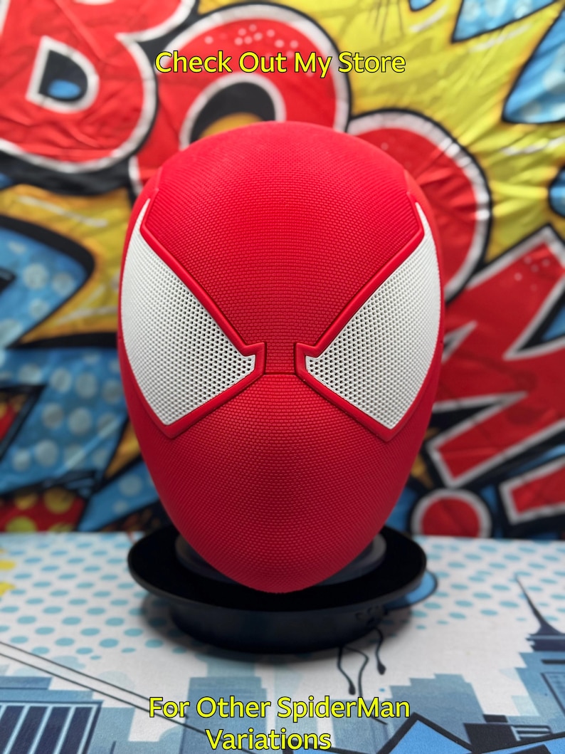 May include: A red Spider-Man mask with white eye details and a black base. The mask has a textured surface and is displayed against a colorful comic book-style background. Text on the image reads "Check Out My Store" and "For Other SpiderMan Variations."