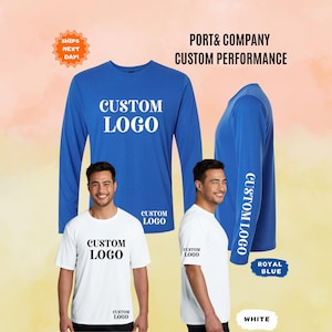 May include: A royal blue long-sleeve shirt and a white short-sleeve shirt, both featuring the text CUSTOM LOGO. The royal blue shirt displays the text on the chest and sleeve, while the white shirt displays the text on the chest and lower hem.