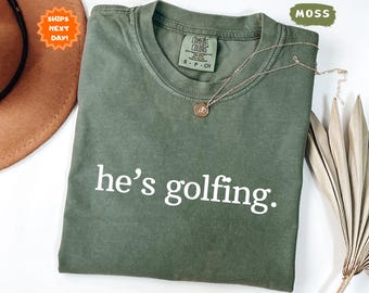 Comfort Colors® He's Golfing Shirt, Golfing Season Shirt, Golfer Wife Shirt, Golf Lover Shirt, Golf Girlfriend Shirt, Golf Player Gift