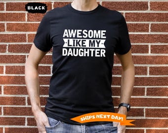May include: Black t-shirt with white text that reads "Awesome Like My Daughter".